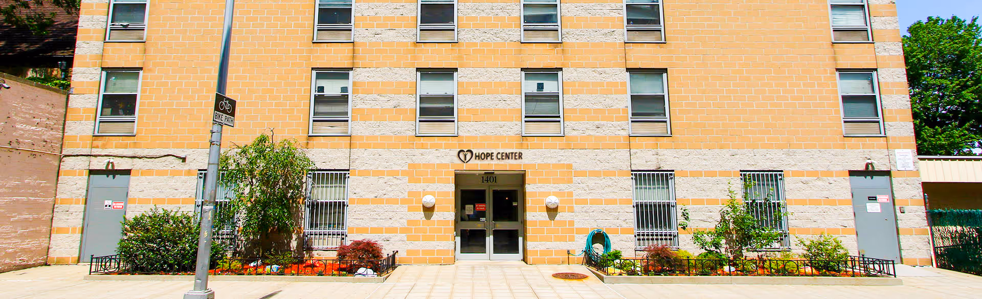 Front facade of the Hope Center building with a central entrance and rows of windows across multiple floors.