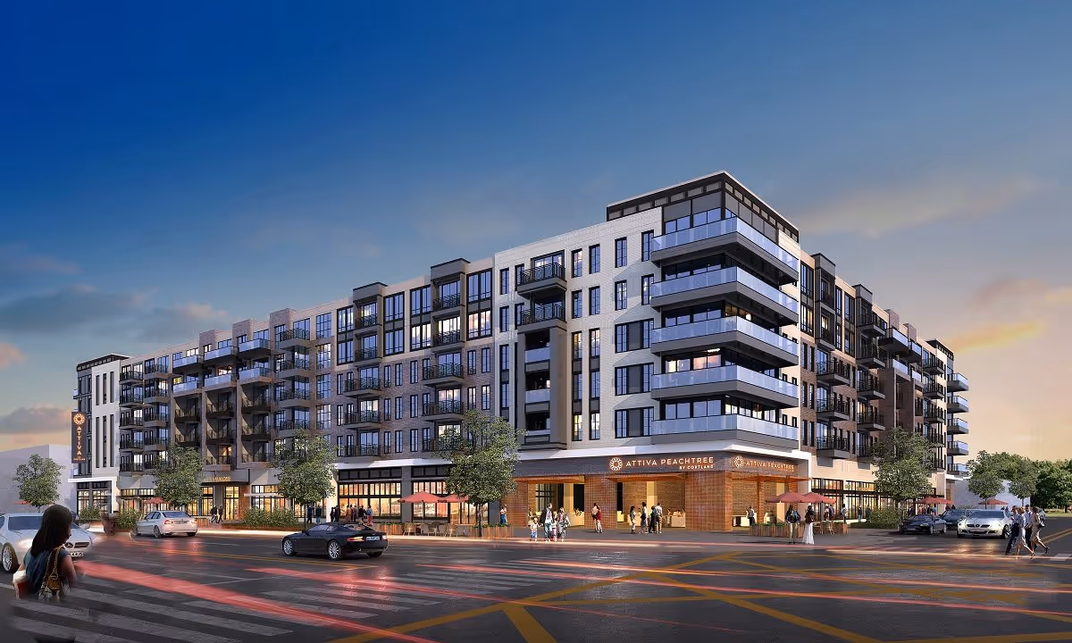 Exterior view of a modern multi-story residential building named Attiva Peachtree during dusk, with people walking on the sidewalks and cars on the street in front.
