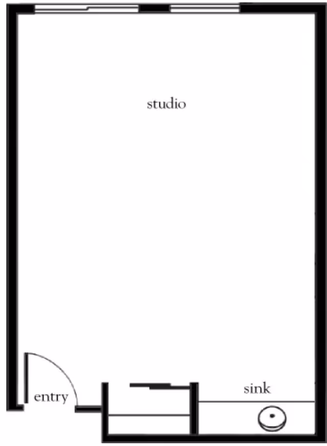 Floor plan of a studio apartment showing an entry door, a main studio area, and a small section with a sink.
