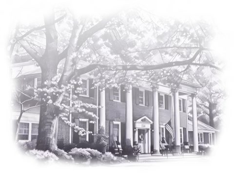 Front exterior of a brick retirement home with columns and outdoor seating.