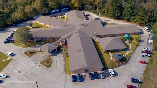 Aerial view of Southland Rehabilitation And Healthcare Center showing a large, single-story building with multiple wings arranged in a star-like pattern, surrounded by parking lots and trees.