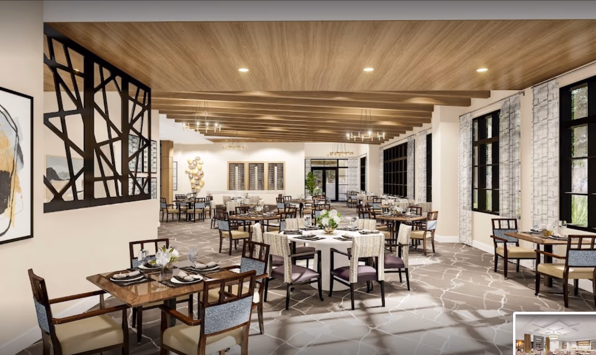 Spacious, well-lit dining room with multiple set tables, wooden ceiling beams, large windows, and decorative partition.