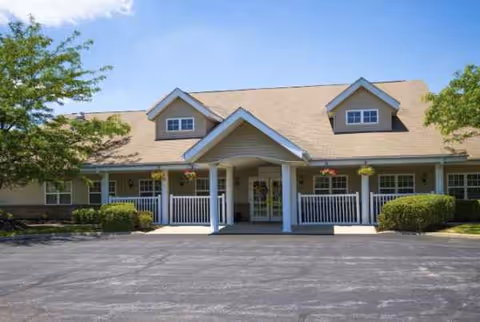 Front exterior of Worthington Place senior living facility with a covered entrance