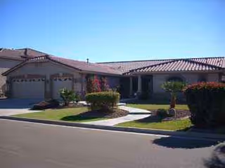 Single-story assisted living facility with a landscaped front yard and covered entrance.