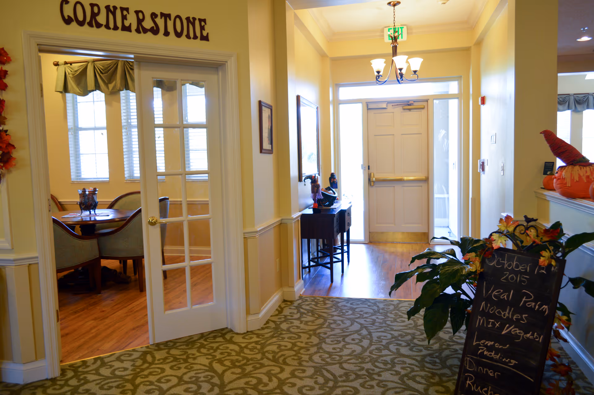 Interior hallway at The Opal at Spring Hill with dining room doorway and chalkboard menu.