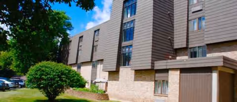 Exterior view of Shepherd of the Valley Niles building with brick base and surrounding trees.