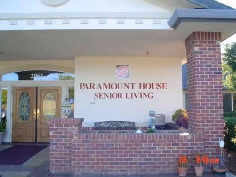 Front entrance of Paramount House Senior Living with brick columns and signage.