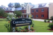 Exterior view of Converse Home building with a landscaped lawn and sign.