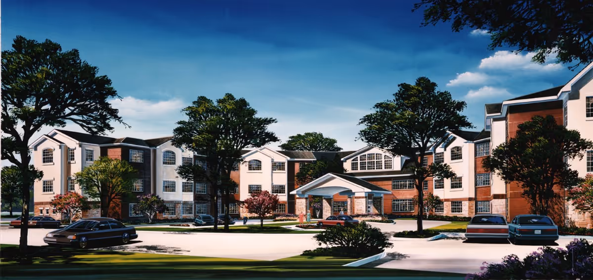 Exterior view of a large, multi-story retirement living facility named Mountain Creek Retirement Living, surrounded by trees and parked cars under a blue sky with some clouds.