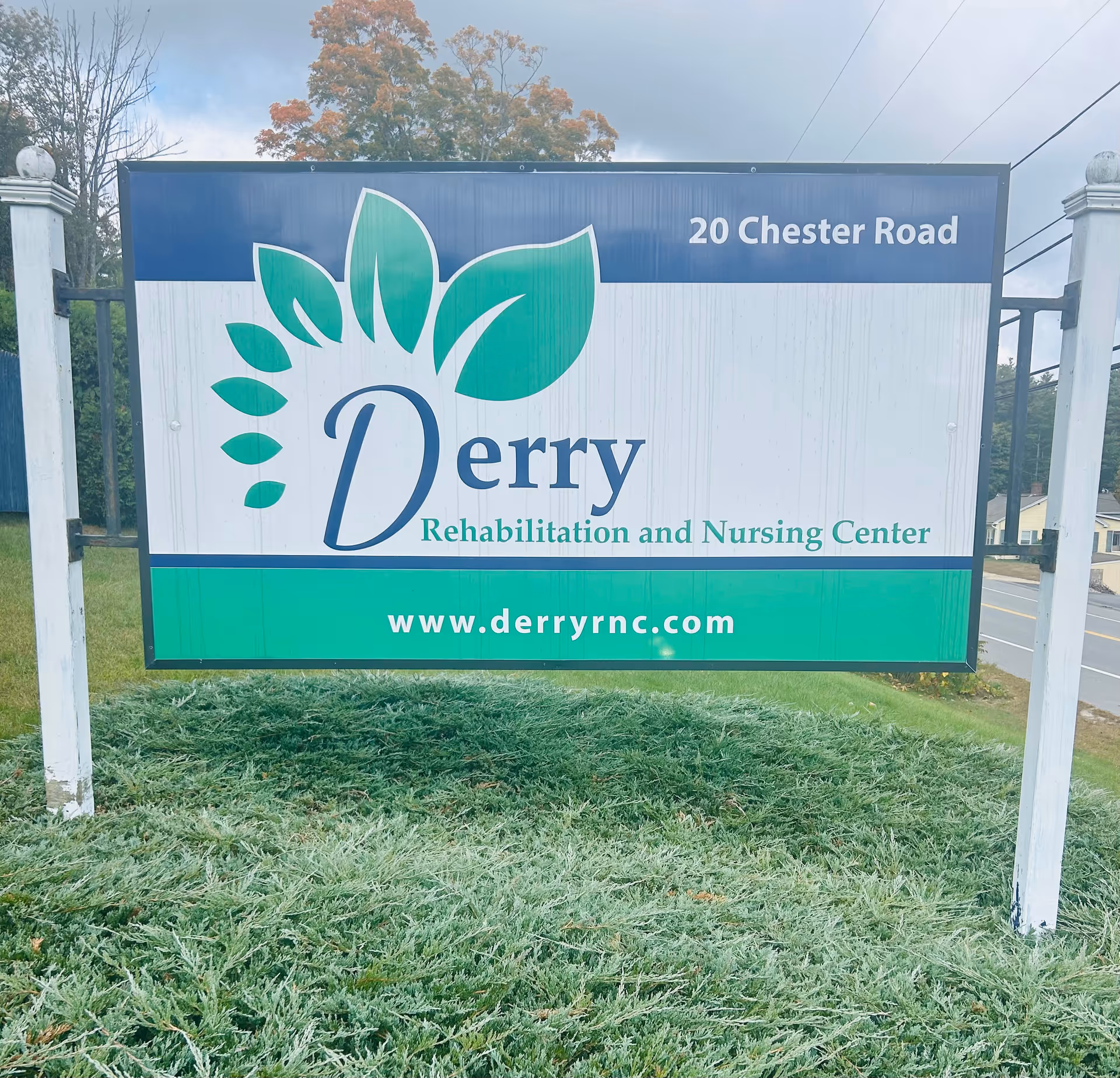 Roadside sign reading "Derry Rehabilitation and Nursing Center" with the address "20 Chester Road" and website "www.derryrnc.com".