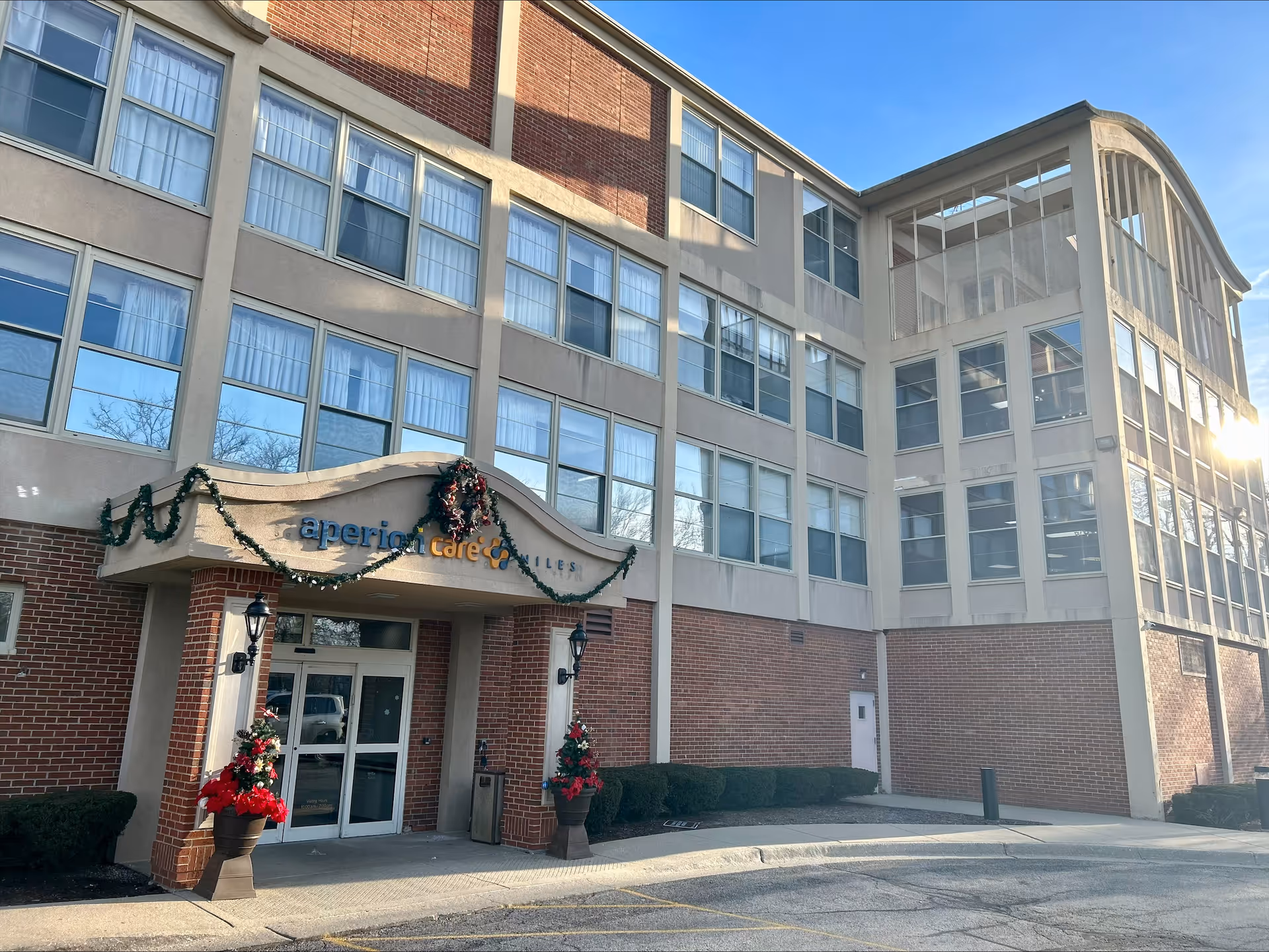 Exterior view of Aperion Care Niles senior living facility with festive decorations.