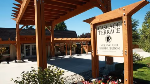 Outdoor entrance with wooden pergola and Cascade Terrace Nursing and Rehabilitation sign.