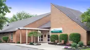 Exterior view of Circleville Post Acute, brick building with shrubs at the entrance.