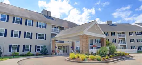 Exterior view of Brookdale Eddy Pond senior living with covered entrance and landscaped roundabout.