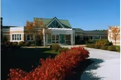 Exterior view of Schuyler Ridge Residential Healthcare entrance with a landscaped walkway.