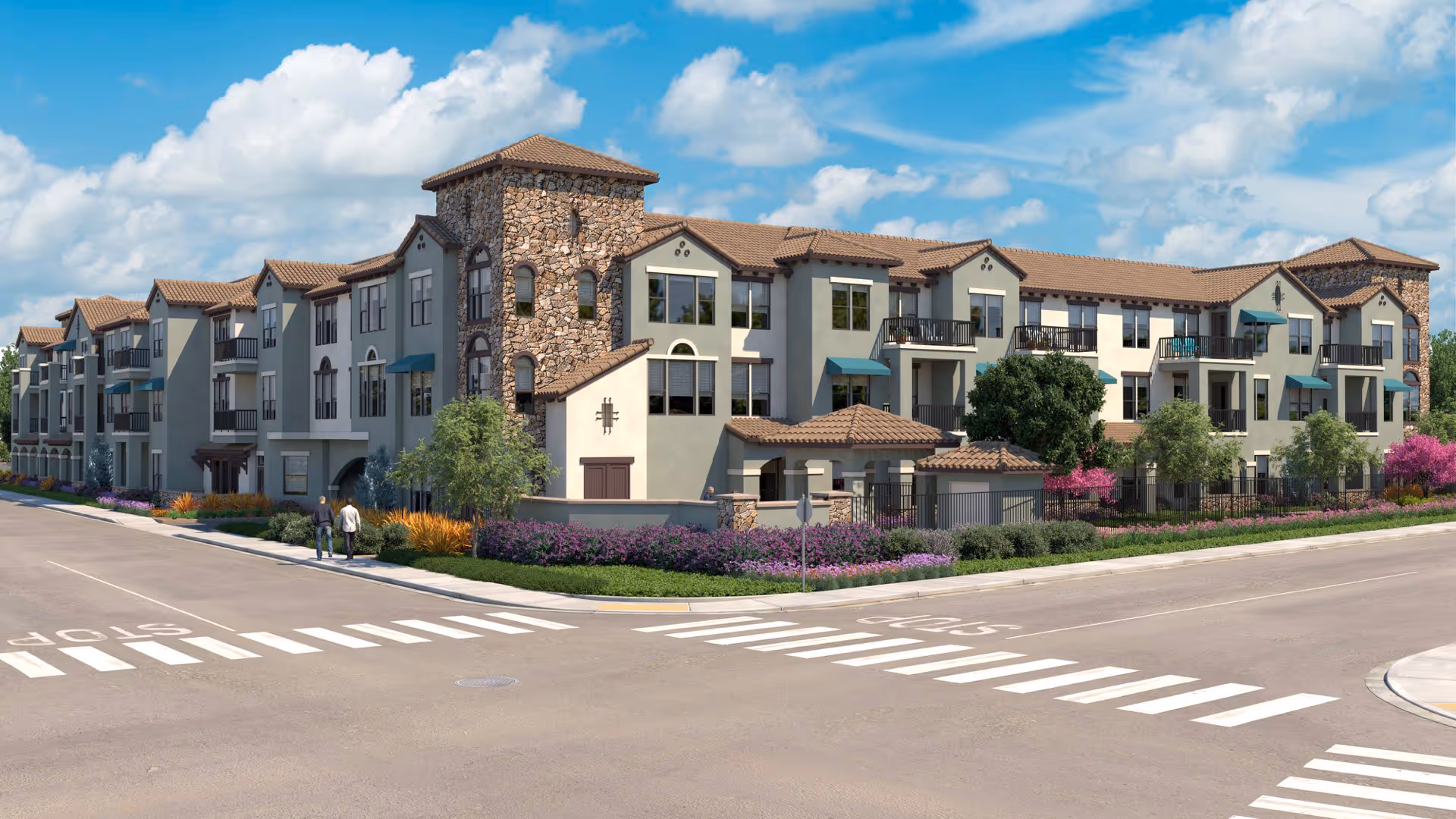 Exterior view of a three-story senior living facility with stone and stucco facade, multiple windows, balconies, and landscaped surroundings including trees and flowering plants under a partly cloudy sky.
