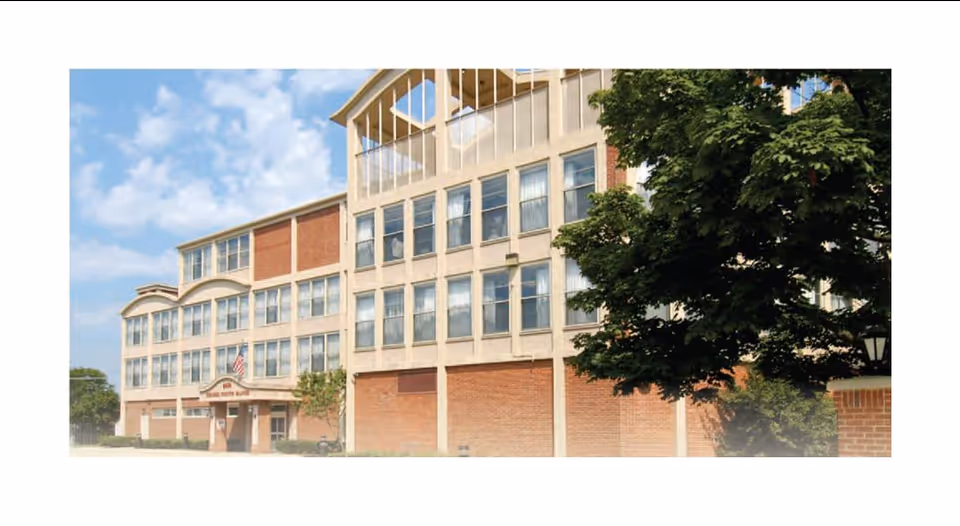 Exterior view of Aperion Care Niles building with brick facade and trees