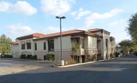 Exterior view of Ararat Home of Los Angeles, a beige building with a red-tiled roof.