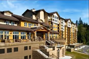 Exterior view of Timber Ridge at Talus, a multi-story senior living building with terraces.