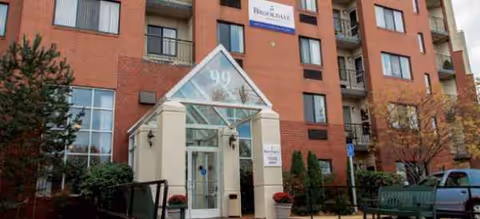 Red brick senior living building with glass entrance and Brookdale signage.