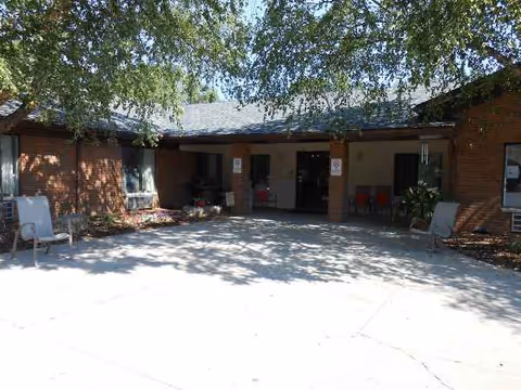 Front entrance of Envive Healthcare of Sullivan, brick exterior with chairs outside.