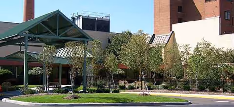 Exterior view of St Augustine Health Campus with entrance canopy and landscaped circular drive.