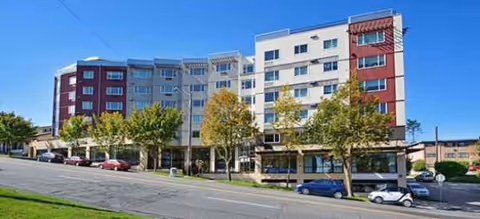 Exterior view of Brookdale West Seattle senior living building along a tree-lined street.