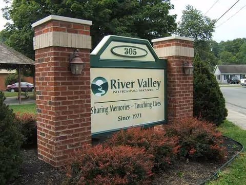 River Valley Nursing Home entrance sign with brick pillars and shrubs