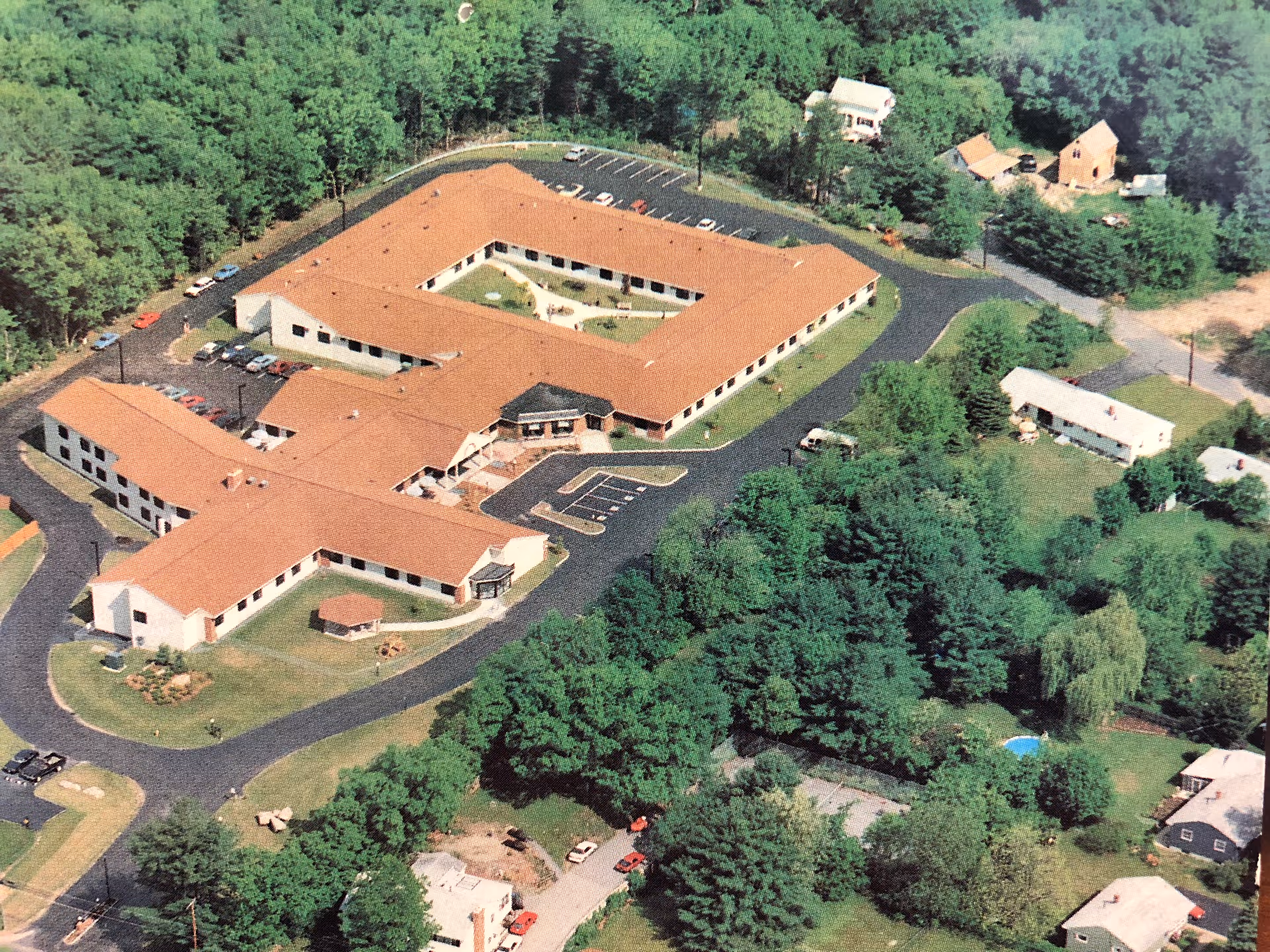 Aerial view of Villa Crest Nursing and Retirement Center surrounded by greenery.