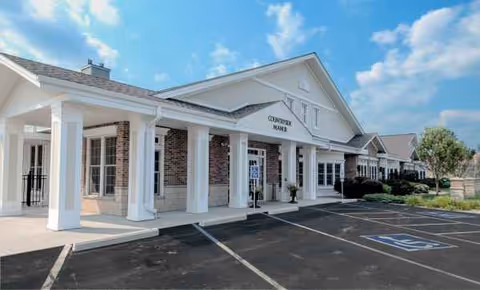 Exterior view of Countryside Manor with a covered entrance, columns, and handicapped parking.