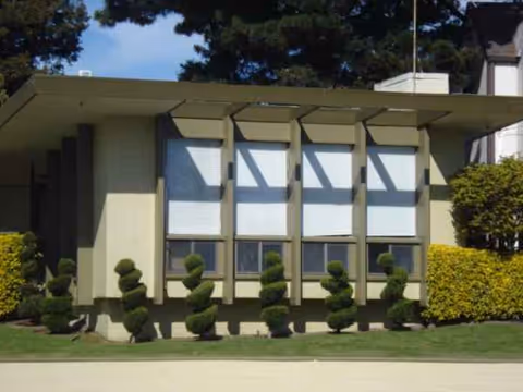 Front view of Marina Garden Nursing Center exterior with large windows and manicured shrubs
