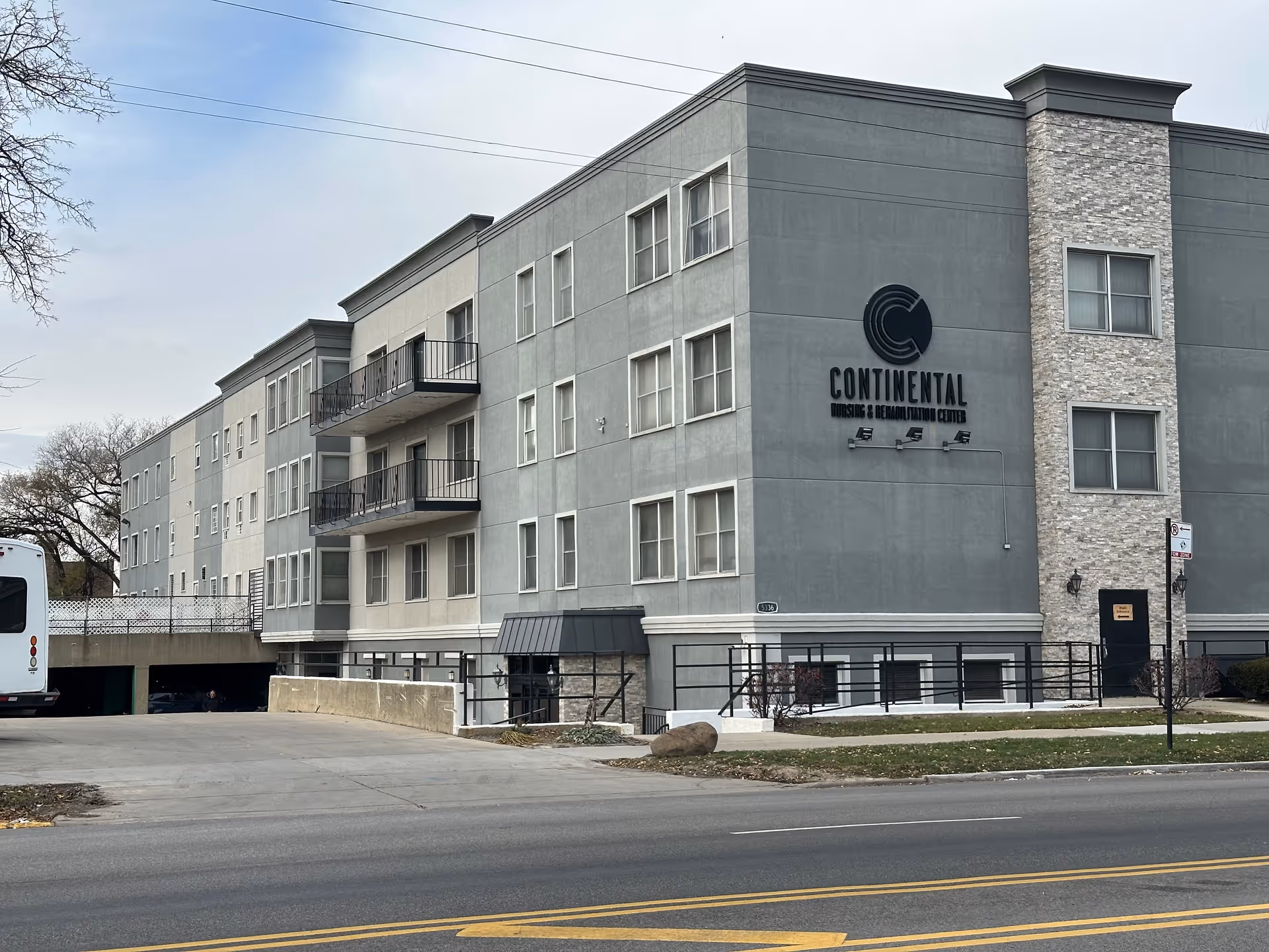 Front exterior of Continental Nursing & Rehabilitation Center, a multi-story gray building with balconies and visible signage.