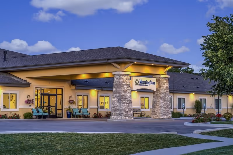 Front entrance of a single-story senior living facility with a covered porte-cochère and a sign reading "MorningStar Memory Care".