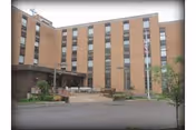 Brick exterior of Allied Services Meade Street Skilled Nursing with entrance and benches.
