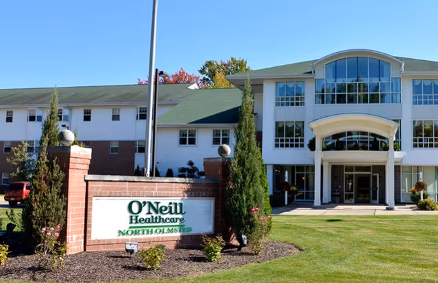 Exterior view of O'Neill Healthcare North Olmsted building with a large sign in front surrounded by landscaping and a well-maintained lawn.