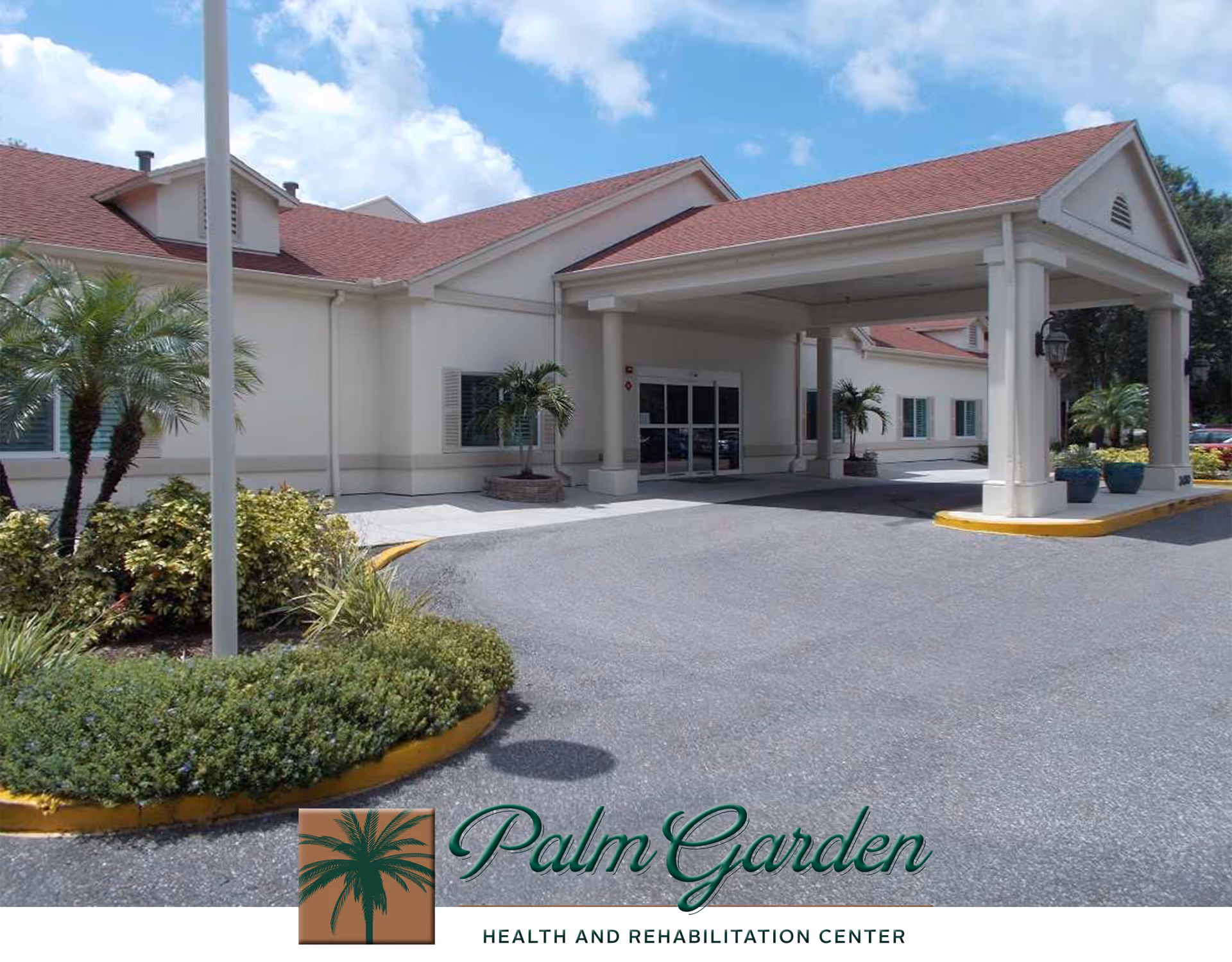 Exterior view of Palm Garden of Clearwater health and rehabilitation center showing the building entrance with a covered drop-off area, landscaped greenery, palm trees, and a clear blue sky.