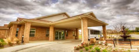 Exterior of Remarkable Healthcare of Dallas with brick entrance and landscaped walkway.