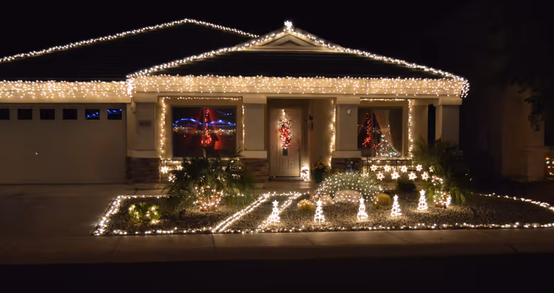 Front view of AZ Life Assisted Living Home adorned with festive holiday lights.