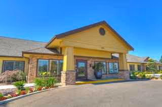 Front view of Sierra Ridge Memory Care building with a covered entrance.