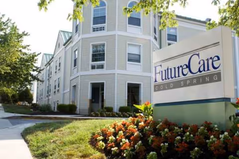Exterior view of FutureCare Cold Spring facility with sign and landscaped entrance.