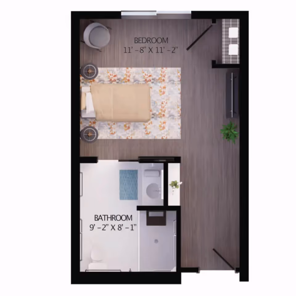 Floor plan of a senior living unit showing a bedroom measuring 11 feet 8 inches by 11 feet 2 inches with a bed, two side tables, a chair, a TV, and a plant. Adjacent to the bedroom is a bathroom measuring 9 feet 2 inches by 8 feet 1 inch with a toilet, sink, and shower area.