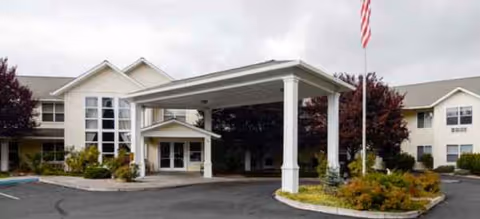 Front view of Klamath Falls Senior Living with porte-cochère and flagpole