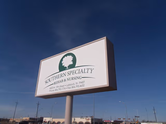 A large outdoor sign for Southern Specialty Rehab & Nursing located at 4320 W. 19th Street, Lubbock, TX 79407, with phone and fax numbers displayed, set against a clear blue sky.