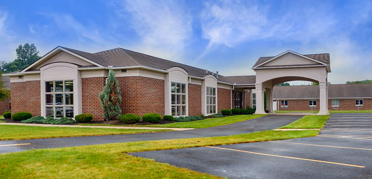 Lisbon skilled nursing facility exterior with landscaped grounds and a covered entrance.