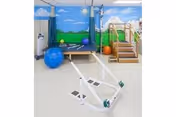 Indoor activity room with muraled walls, steps, and workout/play equipment.