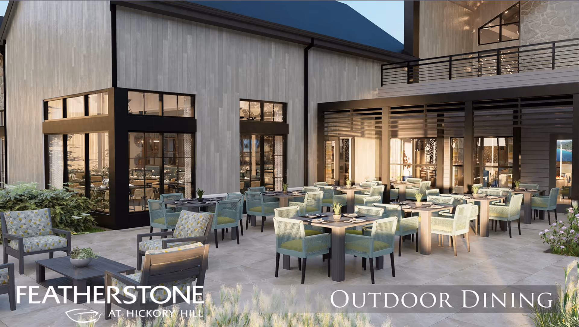 Outdoor dining area at FeatherStone at Hickory Hill featuring multiple tables with green cushioned chairs arranged on a tiled patio. The area is adjacent to a building with large windows and a covered section, with some plants and greenery around the patio.