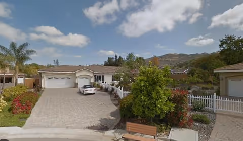 Outdoor view of Silver Oaks Country Estates II with garages, a parked car, and landscaped courtyard.