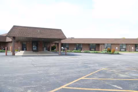Front view of Houghton Rehabilitation and Nursing Center, a single-story brick building with covered entrance.