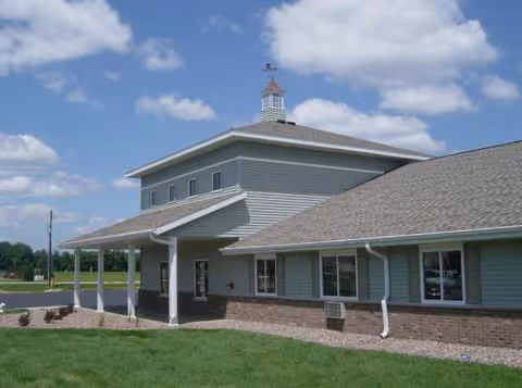 Exterior view of Salem Terrace senior living facility with a covered entrance and blue siding.