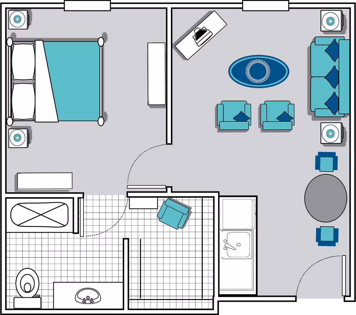 Floor plan of a senior living unit at Oaks at Seneca showing a bedroom with a bed and two nightstands, a bathroom with a toilet, sink, and bathtub, a living room with a sofa, two armchairs, a coffee table, a side table with a lamp, a round dining table with two chairs, and a small kitchen area with a sink and counter space.